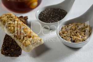 Granola bar and cereals on white background