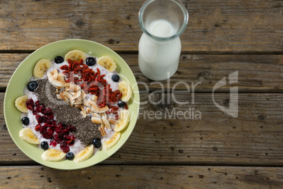 Healthy breakfast and milk on wooden table