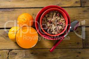 Wheat flakes and orange juice on wooden table