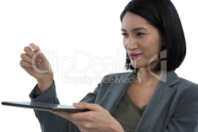 Businesswoman pretending to hold invisible object while using digital tablet