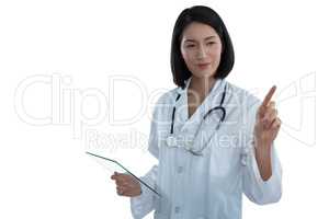 Female doctor holding a glass digital tablet while touching invisible screen
