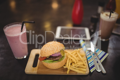 High angle view of fresh burger and fries at cafe