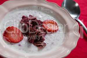 Fruit cereal in bowl on red background