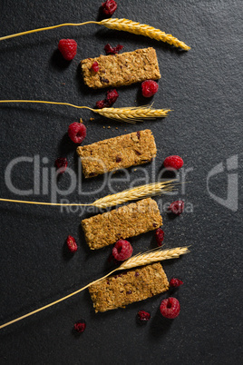 Granola bar with fruits on concrete background