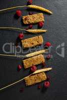 Granola bar with fruits on concrete background