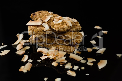 Granola bars with dried coconut on black background