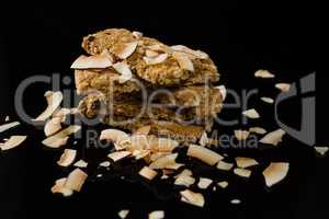 Granola bars with dried coconut on black background