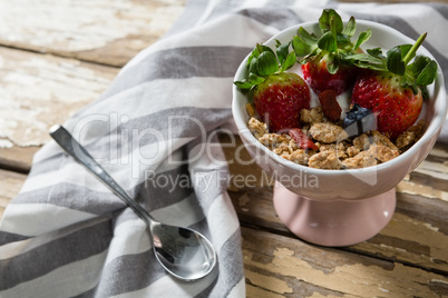 Bowl of wheat flakes with strawberries and blueberry