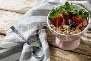 Bowl of wheat flakes with strawberries and blueberry