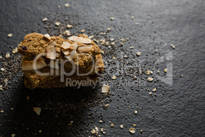 Granola bars with dried coconut and grains on black background