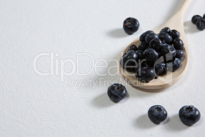 Blueberries arranged in a spoon on white background