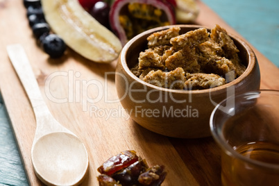 Granola bars in bowl with honey