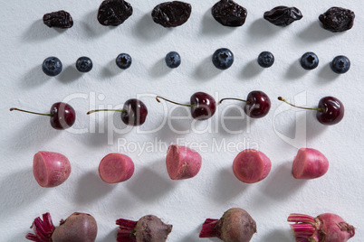 Fruits and vegetables arranged on white background