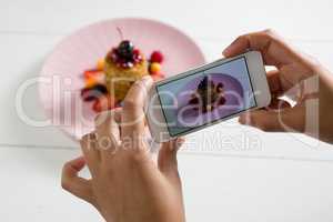 Hands taking photo of breakfast with mobile phone