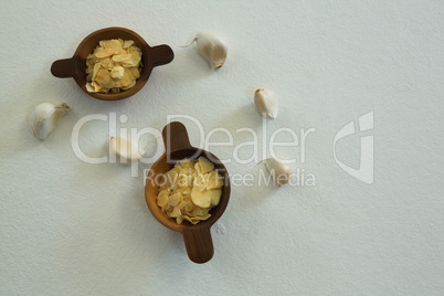 Spices in bowl with garlic on white background