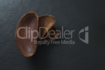 Empty wooden bowl on black background