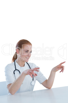 Smiling female doctor using imaginary screen