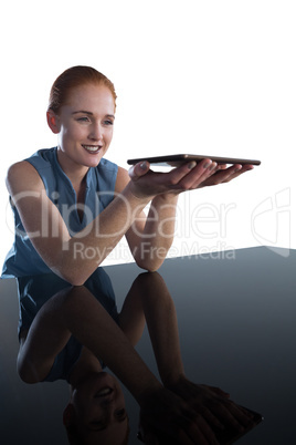 Smiling young businesswoman holding digital tablet