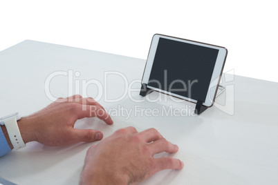 Cropped hands of businessman typing on imaginary keyboard while using digital tablet Cropped hands of businessman typing on imaginary keyboard while using digital tablet