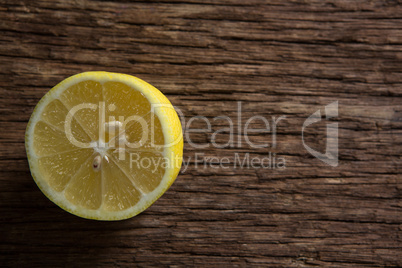 Halved lemon on wooden table