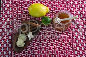 Citrus fruit , cinnamon sticks and honey on a place mat