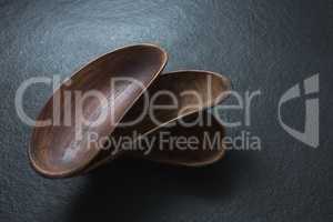 Empty wooden bowl on black background