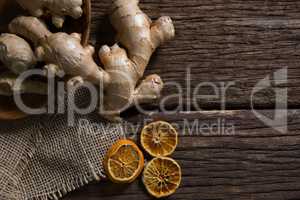 Ginger and dried orange sliced on wooden table