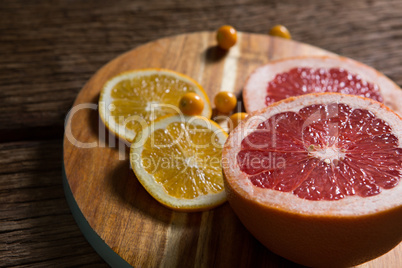 Cape gooseberry with sliced grape fruit and sweet lemon on table