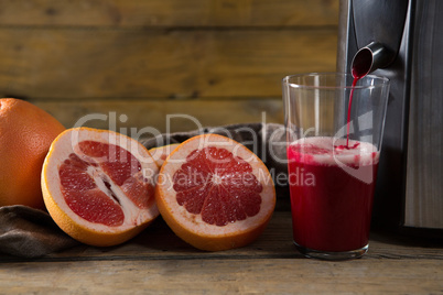 Grape fruit juice being poured in glass
