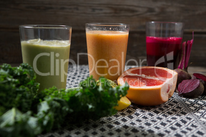 Glass of various juices and paste on table