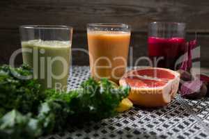 Glass of various juices and paste on table
