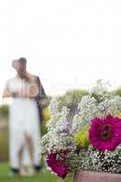 Close up of bouquet with newly couple dancing in background