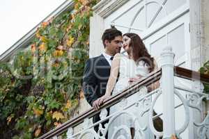 Romantic couple looking at each other while standing in balcony