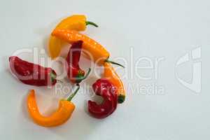 Yellow and red chili pepper on white background