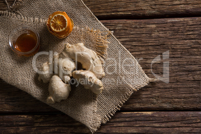 Bowl of orange tea with orange and ginger on textile