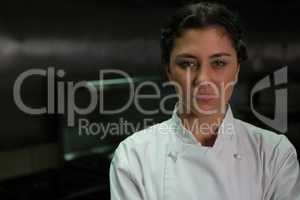 Female chef standing in commercial kitchen