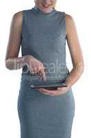 Mid section of smiling businesswoman with digital tablet