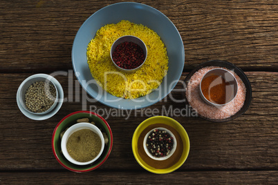 Rice in bowl with various spices ingredients