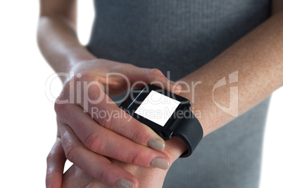 Mid section of businesswoman adjusting smart watch