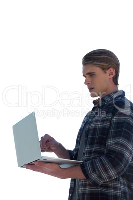 Side view of young businessman using laptop
