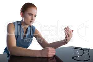 Businesswoman holding invisible product at table