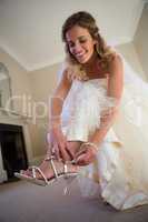 Low angle view of beautiful bride wearing sandals at home
