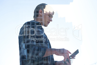 Low angle view of businessman using tablet pc reflecting on window