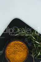 Rosemary with turmeric powder in bowl