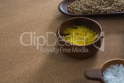 Coriander seeds, rice, and salt in bowl