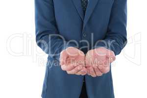 Mid section of businessman with hands cupped advertising invisible product