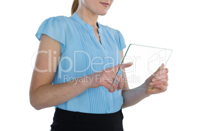 Mid section of young businesswoman using transparent glass interface