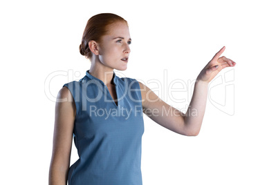 Young businesswoman touching imaginary interface