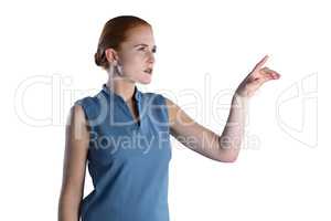 Young businesswoman touching imaginary interface