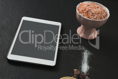 Salt in bowl with digital tablet